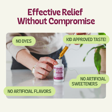 A person uses a syringe to draw liquid from a Kinder Farms bottle. Text labels indicate no dyes, no artificial flavors, no artificial sweeteners, and kid-approved taste.