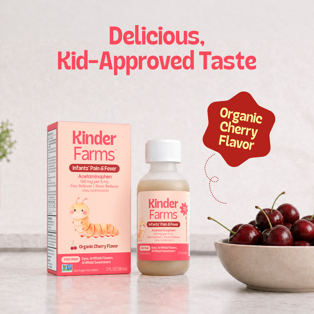 A bottle and box of Kinder Farms Infants' Pain & Fever medicine with cherry flavor, shown next to a bowl of fresh cherries. (Item 7 of 15)