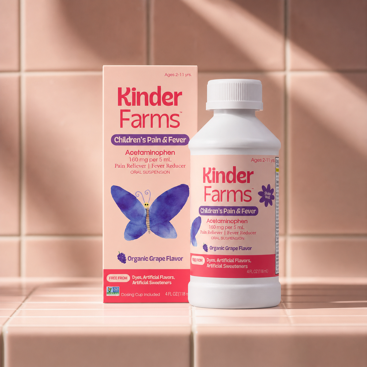 Kinder Farms Children's Pain & Fever acetaminophen bottle and box, organic grape flavor, displayed on a beige tiled surface with warm sunlight and shadows. (Item 9 of 15)