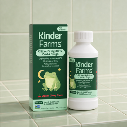 A bottle and box of Kinder Farms Children's Nighttime Cold & Cough medicine, featuring a frog illustration, on a green tiled counter.