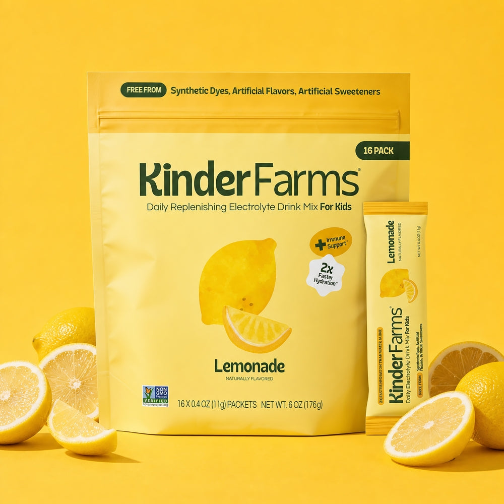 A yellow KinderFarms Lemonade electrolyte drink mix bag and single packet surrounded by fresh lemons on a yellow background.