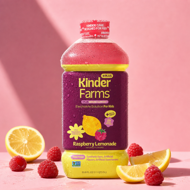 A bottle of Kinder Farms Plus Raspberry Lemonade Electrolyte Solution for Kids surrounded by fresh lemons and raspberries on a pink background.