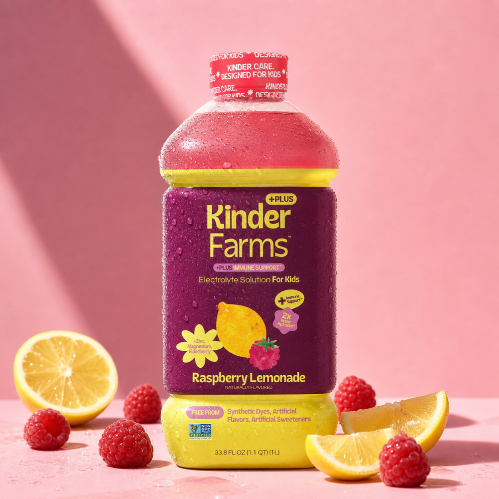 A bottle of Kinder Farms Plus Raspberry Lemonade Electrolyte Solution for Kids surrounded by fresh lemons and raspberries on a pink background.