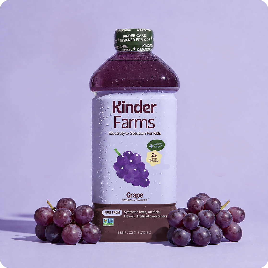Kinder Farms Grape Electrolyte Solution bottle for kids standing between two clusters of fresh purple grapes against a light purple backdrop. (Item 1 of 6)