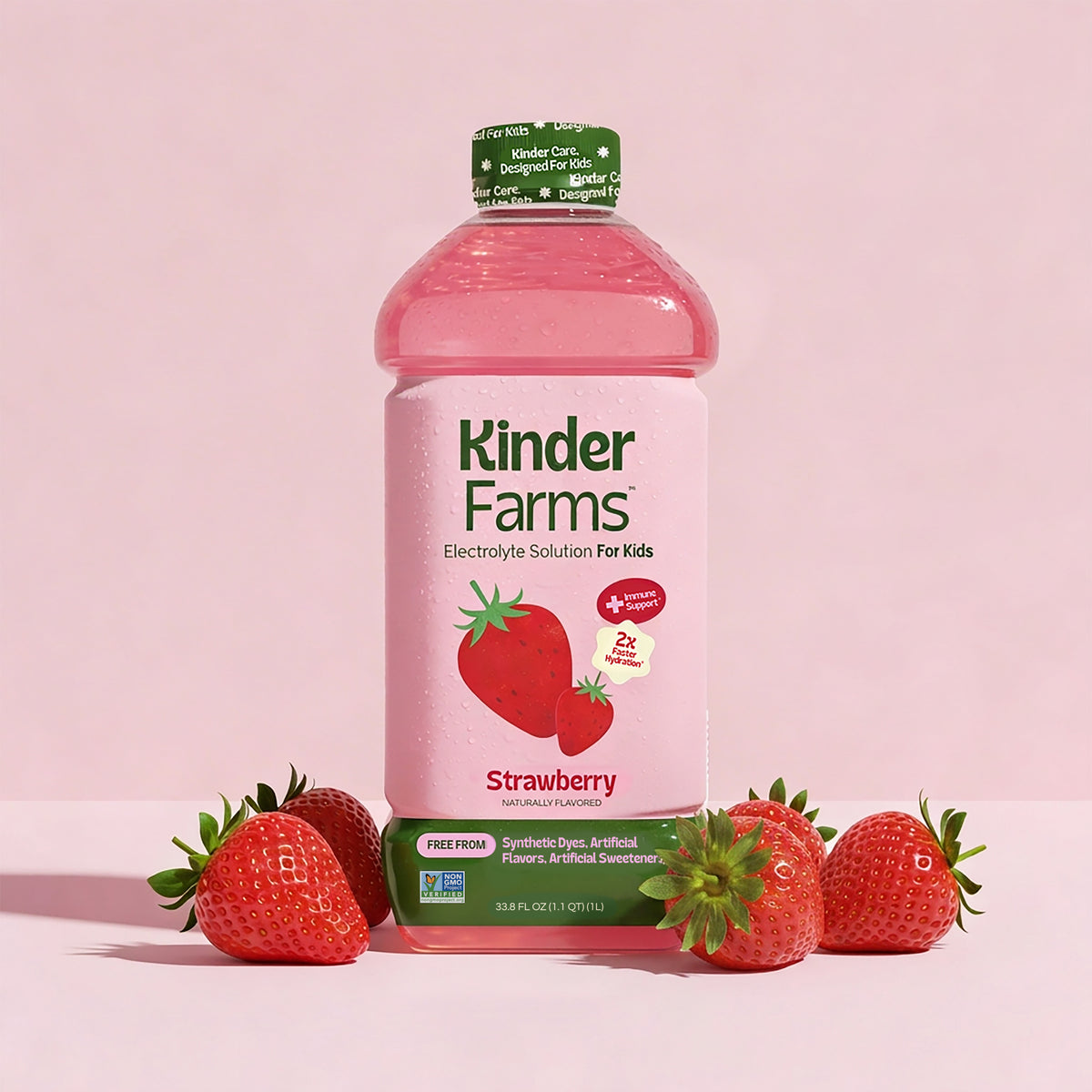 A bottle of Kinder Farms Strawberry Electrolyte Solution for Kids surrounded by fresh strawberries against a pink background. (Item 1 of 6)