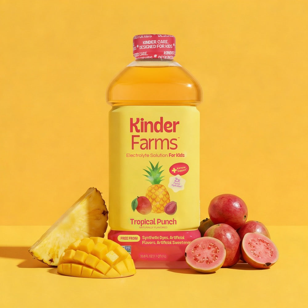 A bottle of Kinder Farms Tropical Punch Electrolyte Solution for Kids surrounded by fresh pineapple, mango, and guava against a yellow background. (Item 1 of 6)