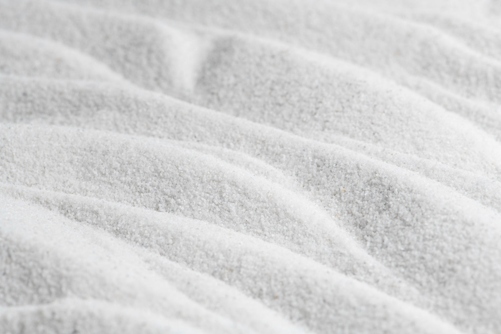 A close-up texture shot of desxtrose with soft ripples and fine granular detail.